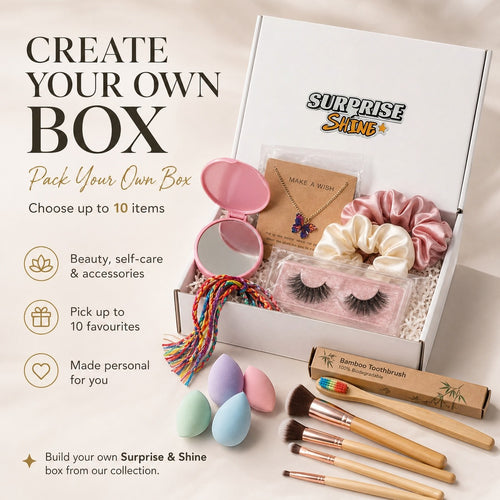 Surprise & Shine customizable gift box with makeup brushes, false lashes, scrunchies, butterfly necklace, makeup sponges, and a compact mirror.